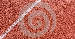 White painted line on tartan ground track in a athleticism and sports field.