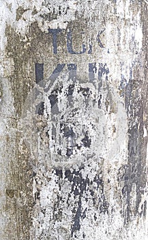 White painted metal pole with not legible text grunge texture