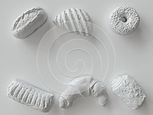 White painted pastry pieces on white background - 3D Rendering