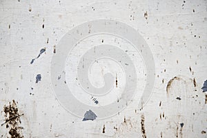 White painted wall with grit and stains, closeup photo texture. Corrosion and distressed marks on metallic surface