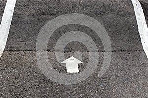 White painting in forward direction arrow symbol on black asphalt road background