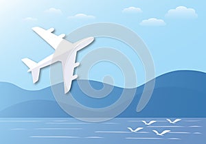 White paper airplane flying in the sky background with mountains, seagull and sea. Travel by air transport concept.