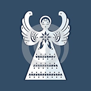 White paper angel with a christmas star on a dark blue background. Beautiful decor angel is form for carving.