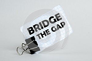 White paper on the white background with text Bridge The Gap