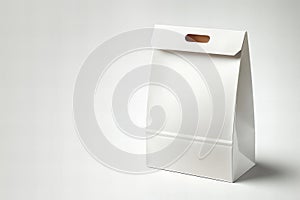 white paper bag with brown handle sits on a white background