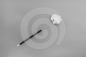 White paper ball with a black pencil on a white background.