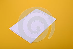 White paper bifold brochure mockup on yellow background