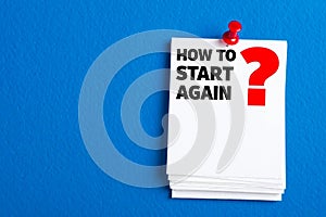White paper with black text how to start again and red question mark pinned image