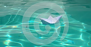 White paper boat sets sail with joy. Experience the magic of childhood as a paper boat glides gracefully on water