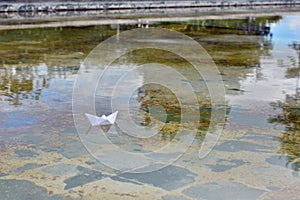 White paper boat on water