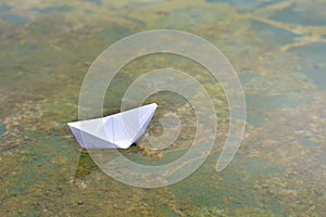 White paper boat on water