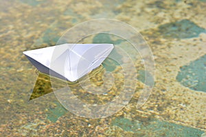 White paper boat on water photo
