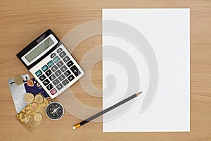 White paper with calculator and pencil on wood background,Office Desk Business concept.