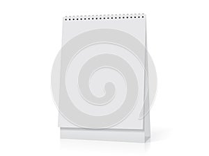 A white paper calendar stands on the table