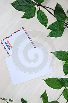 White paper card top view. Air Mail envelope with inscription in French Spanish. Clean table flat lay composition