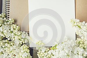 White paper card with white lilac flowers