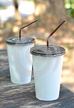 White paper cup with drinking straw