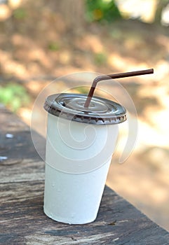 White paper cup with drinking straw