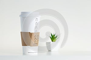 White Paper Cup and green potted plant