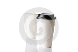 White paper cup for hot coffee with black lid isolated on white background. Takeaway blank small tea cup for your design text or