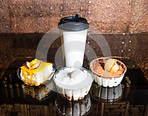 white paper cup and three cakes