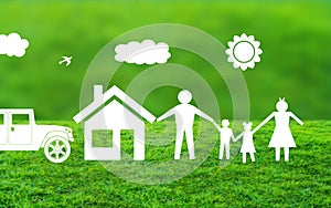 White Paper cut family with house and Car Standing Together on natural Grass in Blurry nature Background