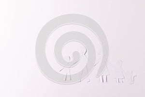 White paper cut out of family with two children and cat and copy space on white background