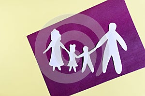 White paper figures of people on a two-color background. The concept of family relations.