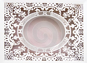 White paper hollow lace oval frame, done in the ornate and luxurious style on a pink background, place for text, room for copy