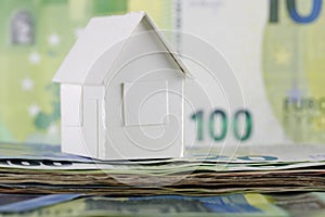 White, paper house model and Euro banknotes