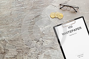 White paper ICO, coins, glasses on gray textured background top view mockup