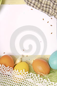 White paper list, Easter background with colored eggs