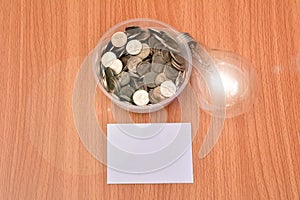 White paper mock up,light bulb for idea and stack coins in glass