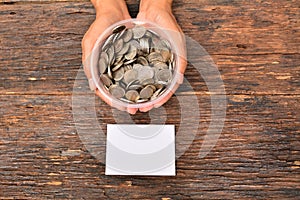 White paper mock up and stack coins in glass put on hand for save money and financial, tax season