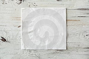 White paper napkin on wooden background