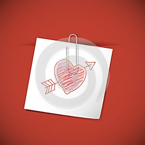 White paper note with clip and red heart