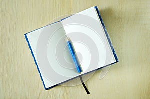 White paper notebook and blue pencil