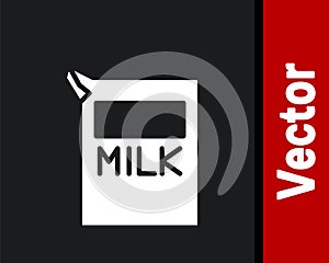 White Paper package for milk icon isolated on black background. Milk packet sign. Vector Illustration