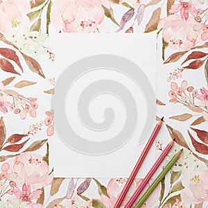 White paper and pencils on pastel watercolor flowers background. Invitation, floral, birthday, Mother`s, Valentines, Women`s, Wedd
