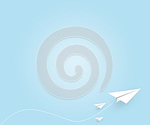 White paper plane flying on blue sky background