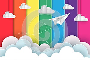 White paper planes fly on the background rainbow colorful while flying above a cloud photo