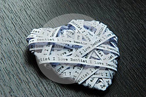 White paper ribbon in heart shape showed text, I love dentist photo