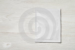 White paper sachet packet on wood table