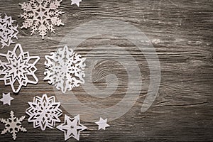 White paper snowflakes on wooden background