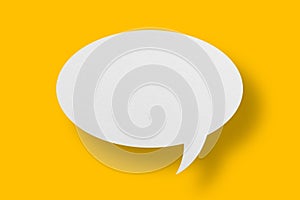 White paper in speech bubble shape set against yellow background