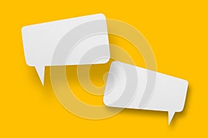 White paper in speech bubble shape set against yellow background