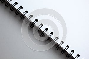 White paper spiral notebook on grey background