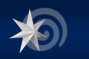 White paper star on blue