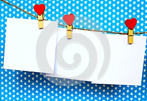 White paper stickers hanging on heart shape pins and pack-thread