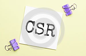 white paper with text csr on a yellow backgroundd with stationery